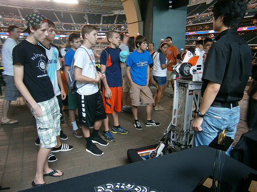 The teams lined up for a group photo with the robots.